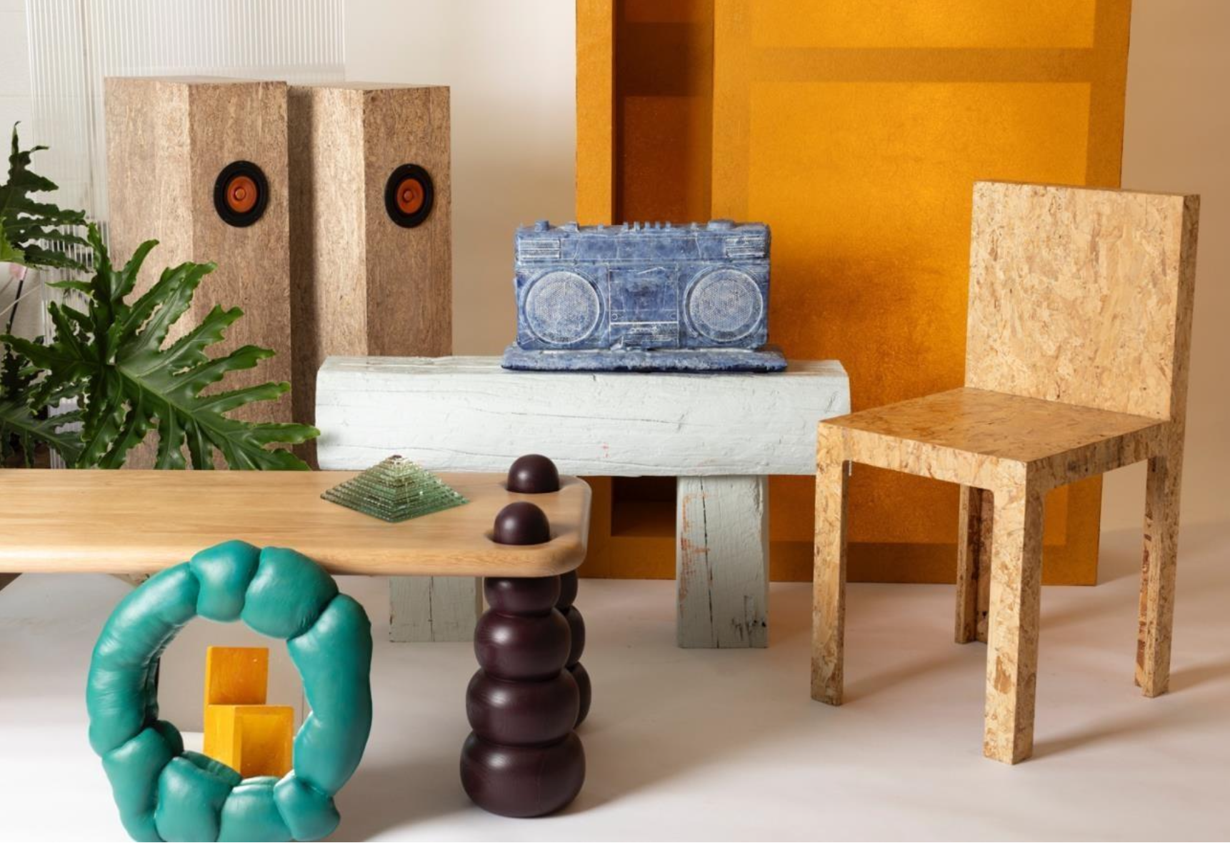 Product and furniture composition with chairs, mirrors, speakers, and sculptural forms